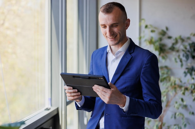 Portrait of a businessman holding a tablet