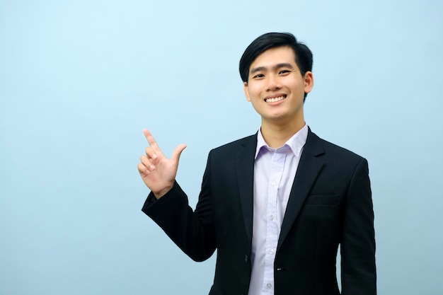 Portrait of businessman pointing and looking at camera