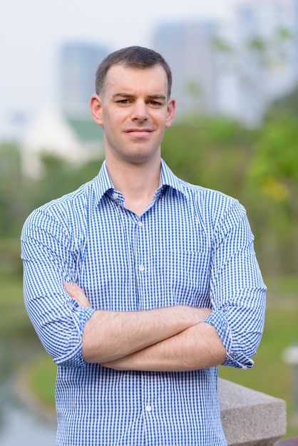 Portrait of businessman relaxing at the park outdoors