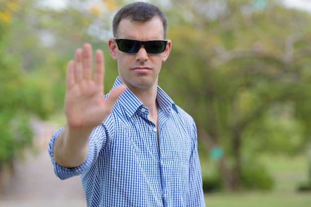 Portrait of businessman relaxing at the park outdoors