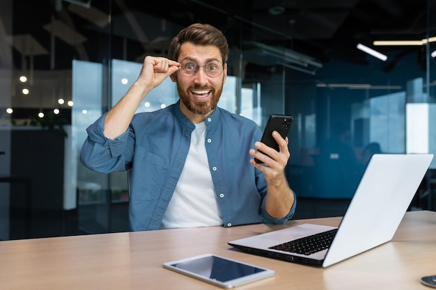 Portrait of a businessman satisfied with the results inside a modern office a man celebrates a