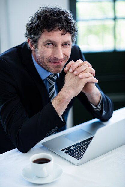 Portrait of businessman smiling in restaurant