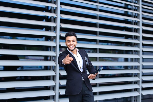 Portrait of businessman standing against wall