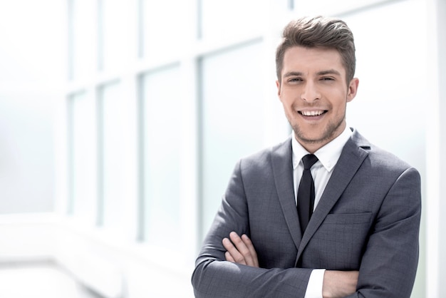 Portrait of a businessman standing near the office window