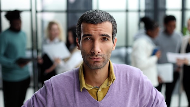 Portrait of businessman standing in office while working day