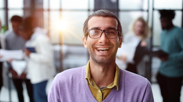 Portrait of businessman standing in office while working day