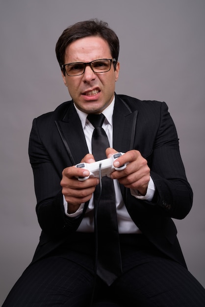 Portrait of businessman in suit playing games