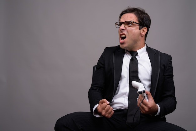 Portrait of businessman in suit playing games