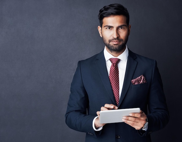 Portrait businessman or tablet in studio mockup space or background for trading planning or research Corporate trader serious indian man in suit or digital technology of online stocks investment