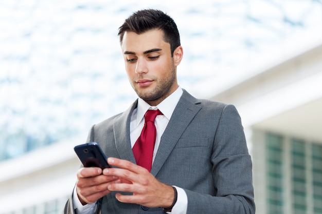 Portrait of a businessman using his mobile phone