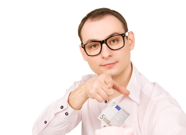 Portrait of businessman with piggy bank and money