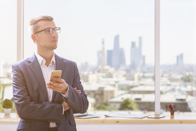 Portrait of businessman with smartphone