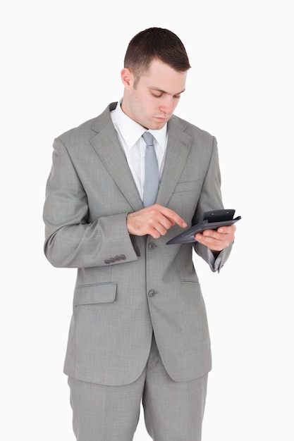 Portrait of a businessman working with a calculator