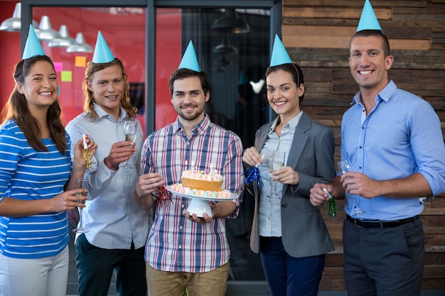 portrait of businesspeople celebrating their colleagues birthday