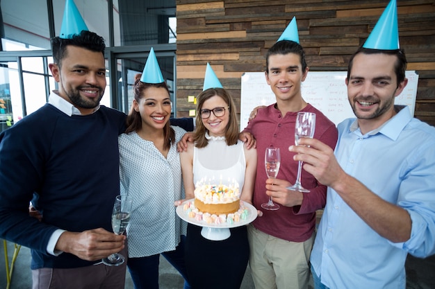 Portrait of businesspeople celebrating their colleagues birthday