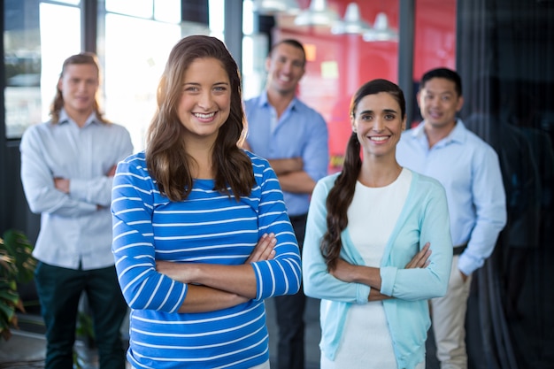 portrait of businesspeople standing with arms crossed