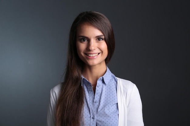 Portrait of a businesswoman against dark background Woman smiling Portrait of a woman