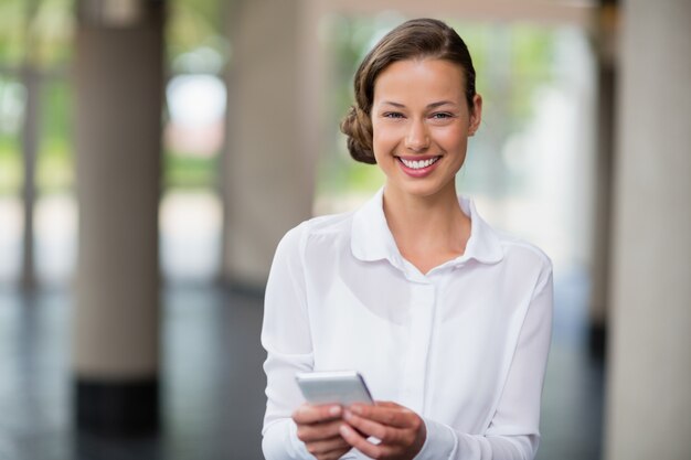 Portrait of businesswoman holding mobile phone