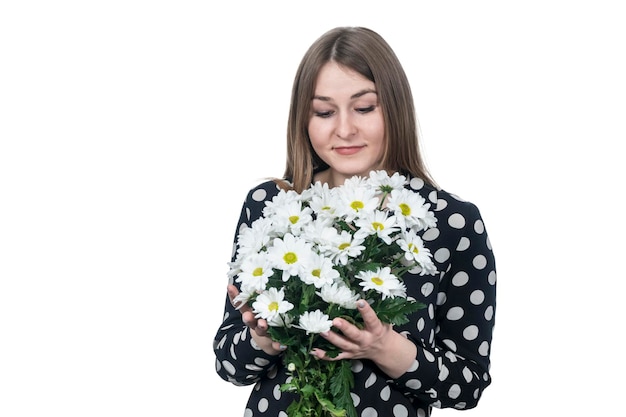 portrait of a businesswoman hugging a bouquet of flowers isolated on white background