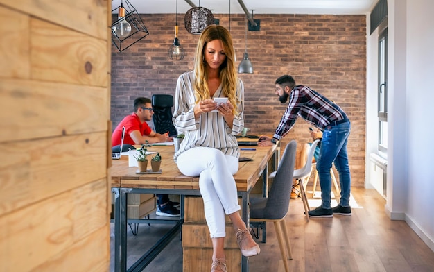 Portrait of businesswoman looking mobile in the office