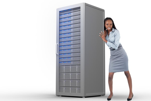 Portrait of a businesswoman pushing a panel against server tower