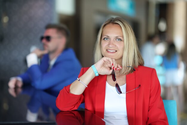 Portrait of businesswoman in red jacket at bar