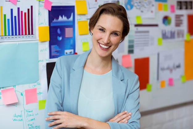 Portrait of businesswoman smiling with arms crossed