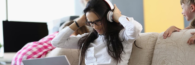 Photo portrait of businesswoman trying to work at home while kids playing and screaming female