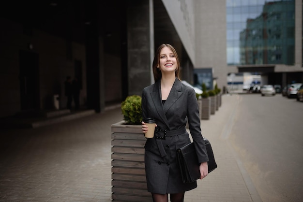 Portrait of businesswoman walking and smiling outdoor