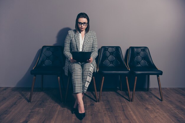 Portrait businesswoman wearing suit holding laptop