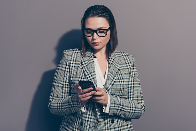 Portrait businesswoman wearing suit and using phone