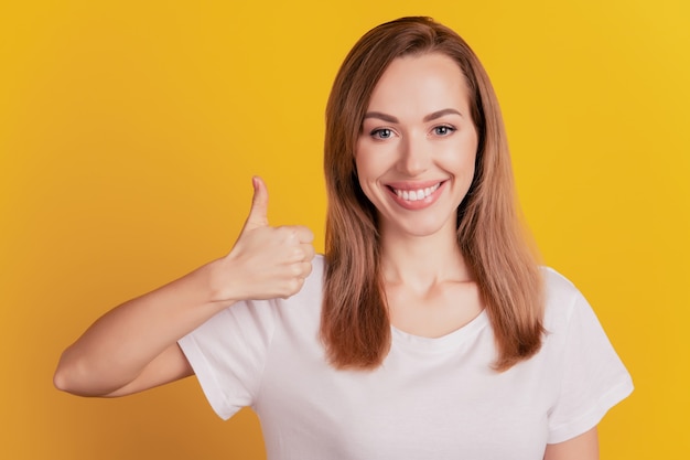 Portrait of businesswoman with thumb up gesture toothy beaming smile