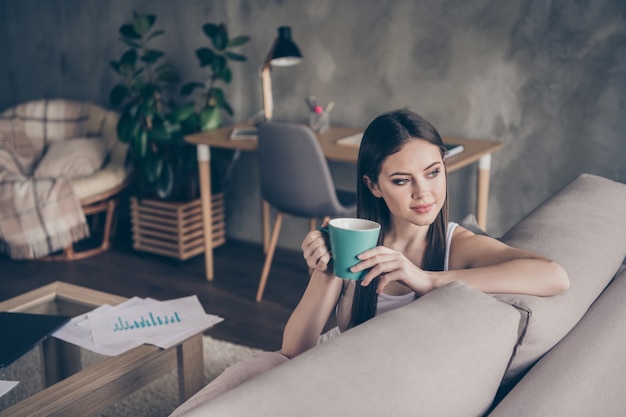 Portrait of calm satisfied girl manager drink hot coffee rest