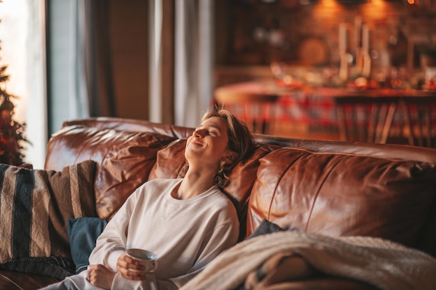 Photo portrait of candid authentic smiling boy teenager having fun emotion at wooden lodge xmas decorated