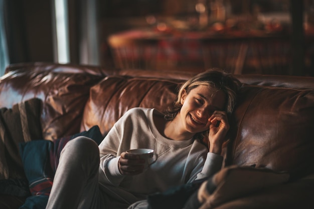 Portrait of candid authentic smiling boy teenager having fun emotion at wooden lodge Xmas decorated