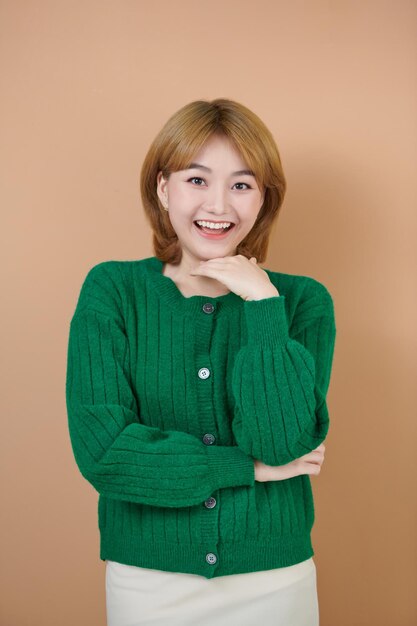 Portrait of candid happy woman smiling and touching chin looking pensive standing