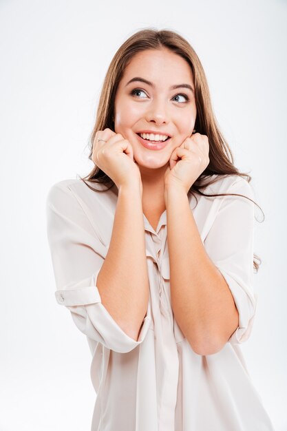 Portrait of a casual happy wondering woman thhinking about something on white wall