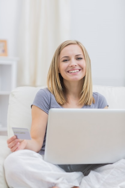 Portrait of casual woman doing online shopping at home