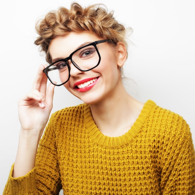 Portrait of a casual woman in glasses looking at camera isolated on a white background