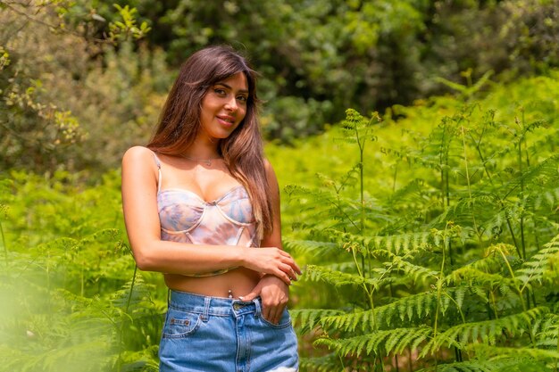 Portrait of a Caucasian girl in ferns on a mountain surrounded by nature enjoying the fresh air