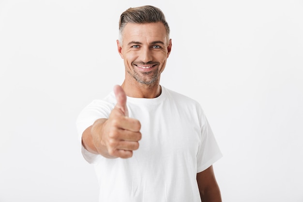 Portrait of caucasian man 30s with bristle wearing casual t-shirt showing thumb up isolated on white