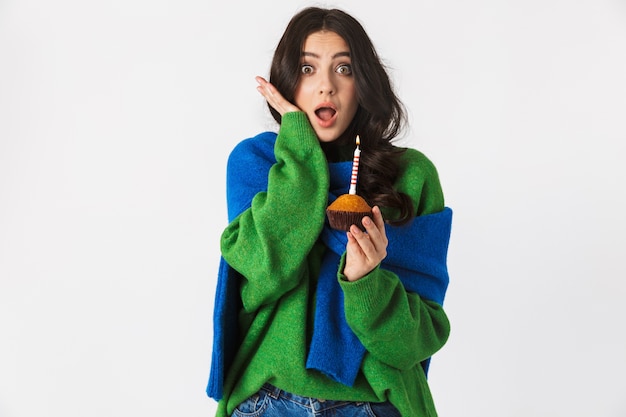 Portrait of caucasian woman in casual clothes holding birthday cake with candle, while standing isolated on white