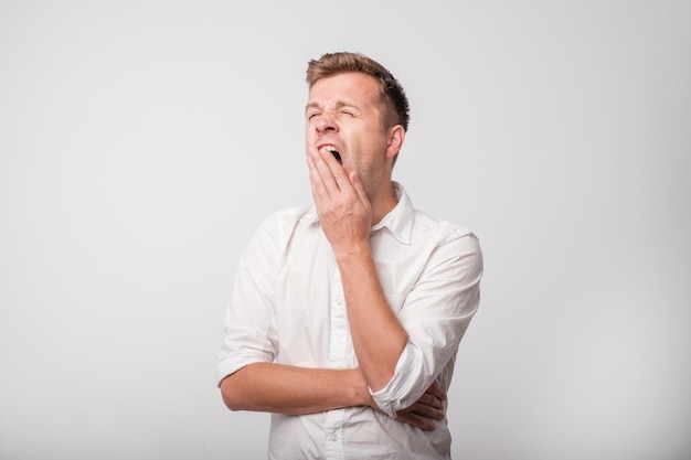 Portrait of caucasian yawning man