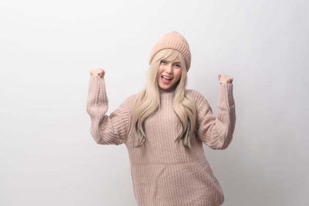 Portrait of Caucasian young woman wearing sweater over white background