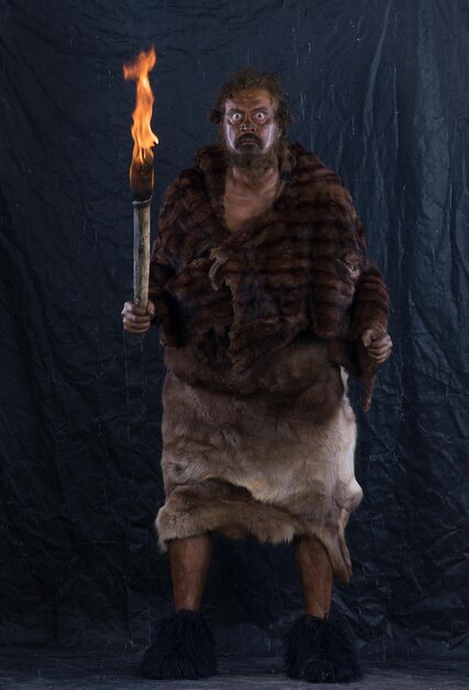 portrait of a caveman with a torch