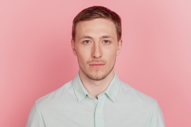 Portrait of charming appealing nice attractive guy look camera on pink background