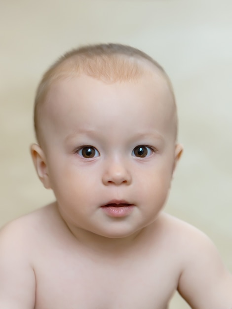 Portrait of charming baby with beautiful big eyes, background blurred, close-up