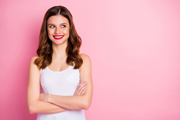 Portrait of charming girl cross hands look side empty space