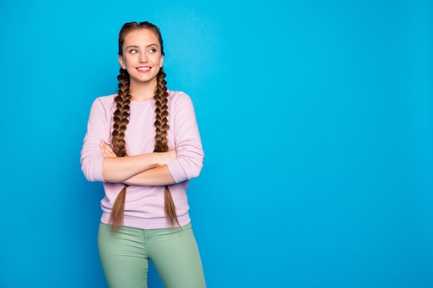 Portrait of charming girl crossing hands looking copyspace having relax on leisure time wearing modern youth outfit isolated over shine color background