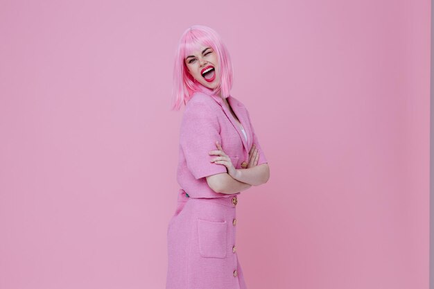 Portrait of a charming lady in a pink suit gesturing with his hands emotions fun pink background unaltered